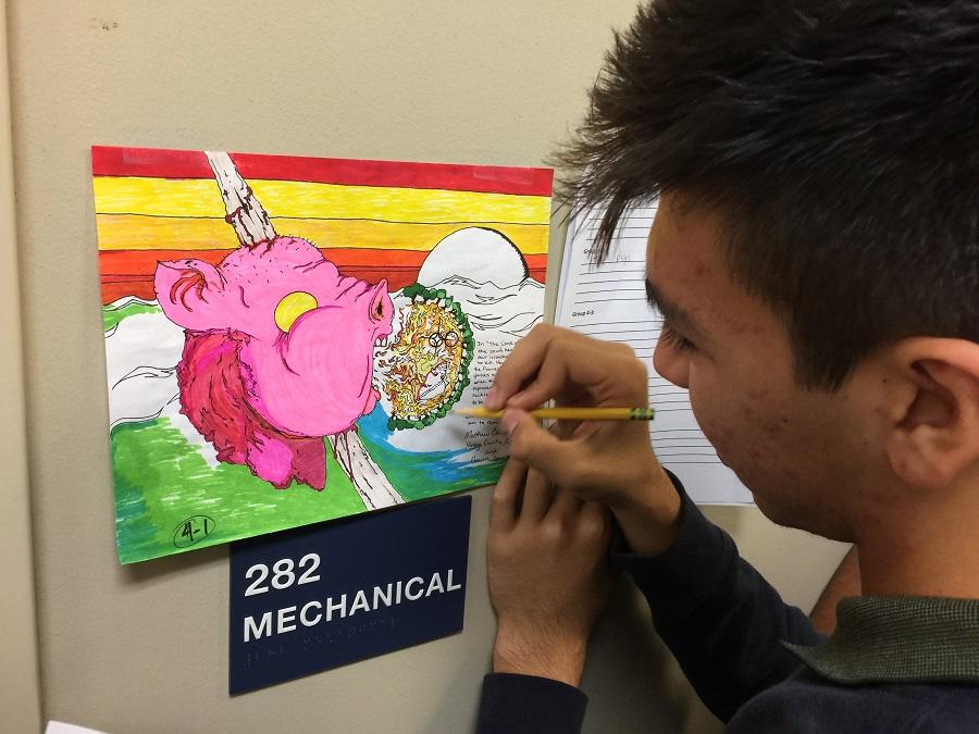 Sophomore Gio Grimaldi takes down comments for illustrations in the "Lord of The Flies" Gallery Walk contest.