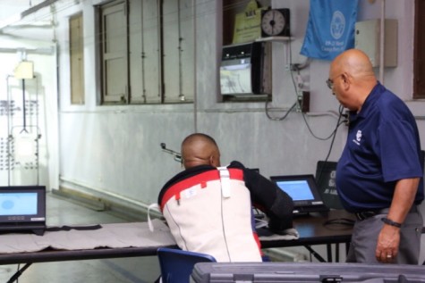 1SG Carrion assists a veteran Wounded Warrior at the Central Catholic Bordelon rifle range.