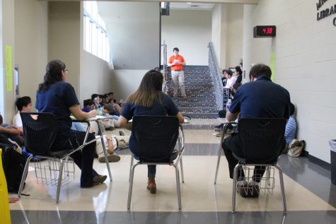 The judges, Ms. Molbert, Ms. Castillo, and Mr. Azano listen as Poetry Slam winner Grant Holmes reads his original poem.